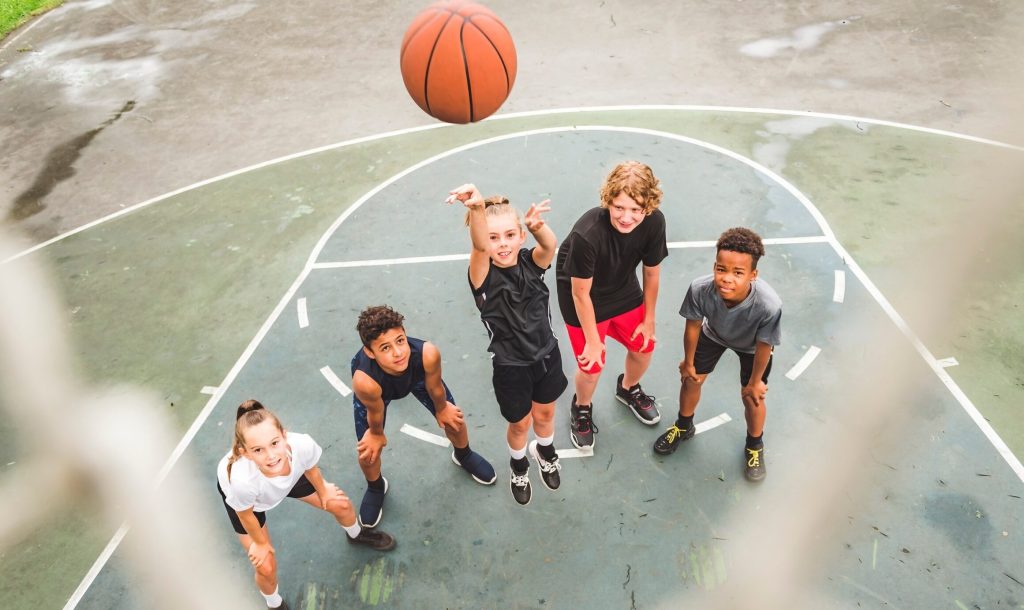 A great child Team in sportswear playing basketball game